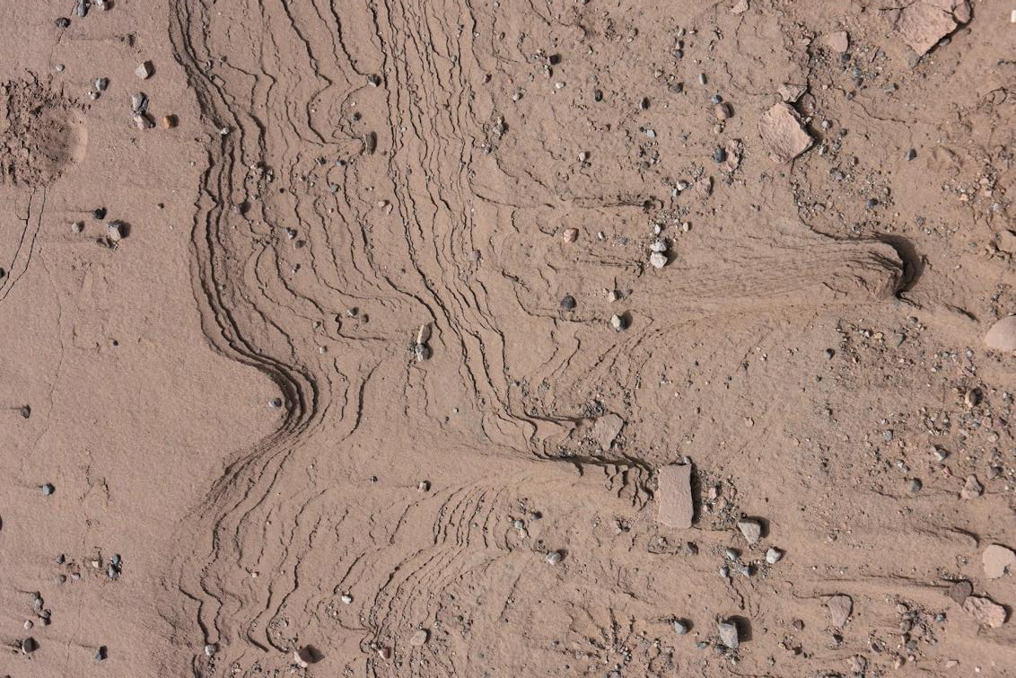 Traces of the sudden passage of water in the muddy bed of kalouts, furrows carved by the constant wind in Dasht-e-Lut, one of the driest and most extreme desert regions on the planet (Region di Kerman, south-eastern Iran)